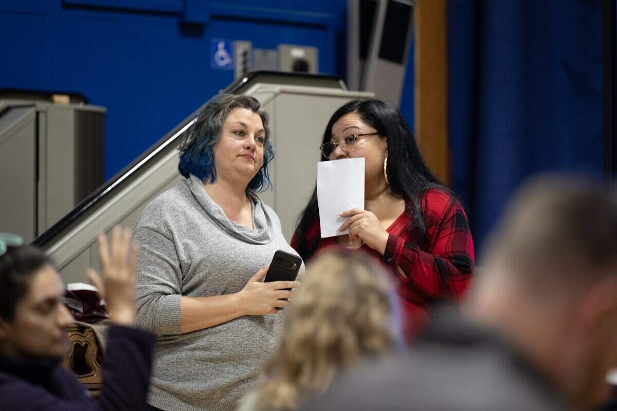 Sacramento City Unified School District board President Tara Jeane, left, and trustee April Ybarra confer during a community meeting at Crocker/Riverside Elementary School on Tuesday.