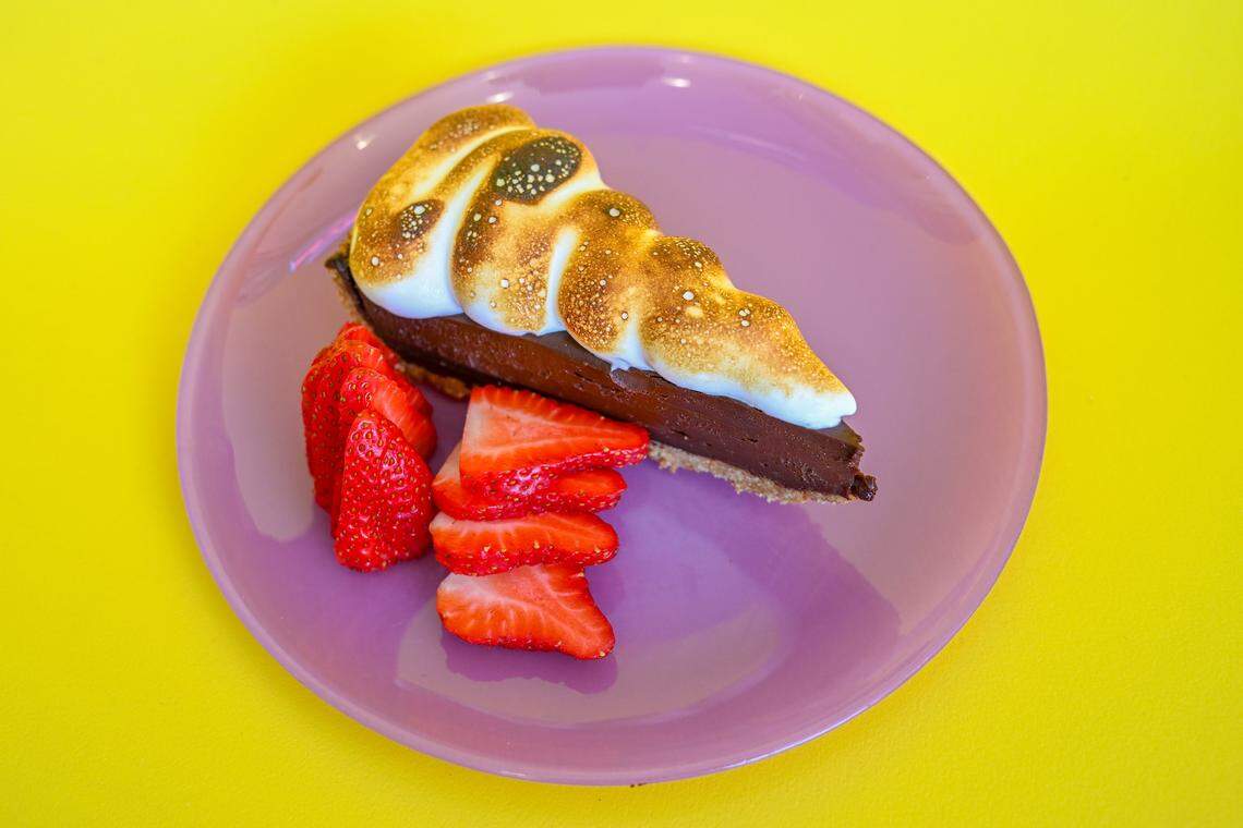 Dark chocolate s’mores pie with almond crust, served with berries, is on the menu at Mother.