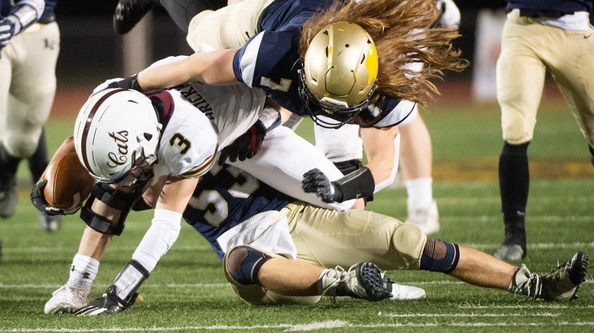 Elk Grove’s Kade Jordan, top, and teammate Jack Spithorst, rear, bring down Whitney quarterback Eli Brickhandler for a sack in the fourth quarter of the high school football Sac Joaquin Section D2 championship game Friday, Nov. 29, 2019, at Sacramento City College’s Hughes Stadium. Elk Grove beat Whitney 35-0.