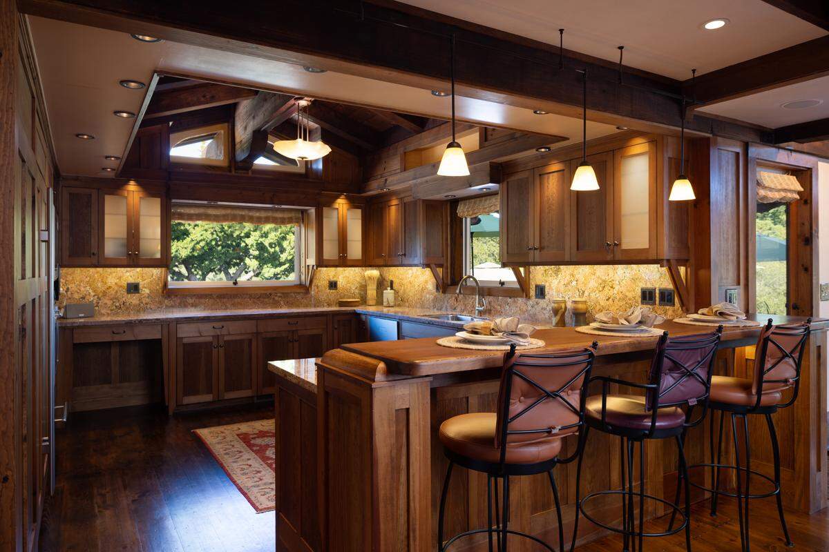 A gourmet kitchen has artisan cabinetry and granite countertops.