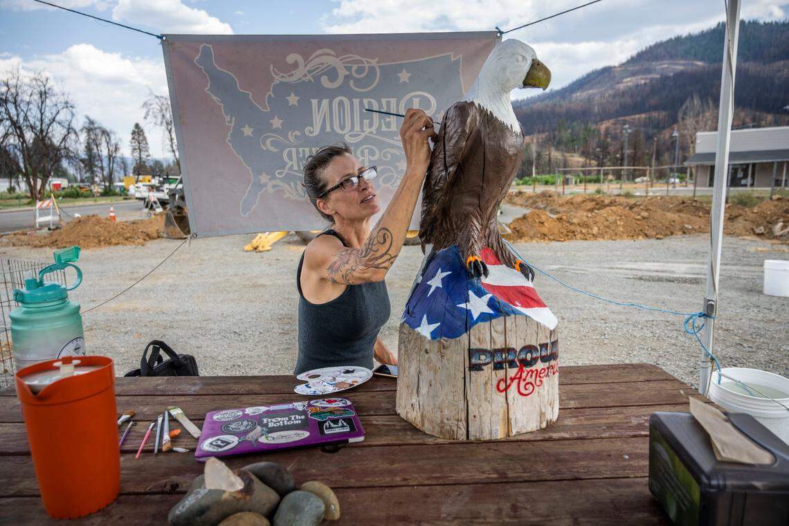 Christi Hazleton, owner of Region Burger, does some paint work on an eagle sculpture Thursday in Greenville. Hazleton lost her business but has reopened a food truck and is part of a business group building a food area called The Spot on Pine Street in Greenville.
