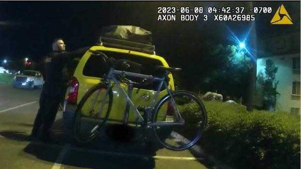 A yellow Nissan SUV, the suspect vehicle in a Folsom burglary case, is examined by an officer on Thursday, June 8, 2023. The suspect was arrested in the parking lot of the Century Folsom 14 movie theaters on Iron Point Road.