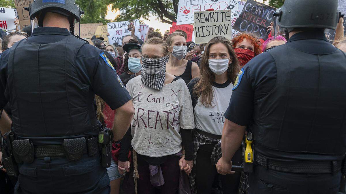 Demonstrators face-off with Sacramento Police officers during a protest organized by Black Lives Matter Sacramento over the death of George Floyd on Friday, May 29, 2020 in Sacramento during the coronavirus pandemic. George Floyd died in Minneapolis Monday after being detained by police.