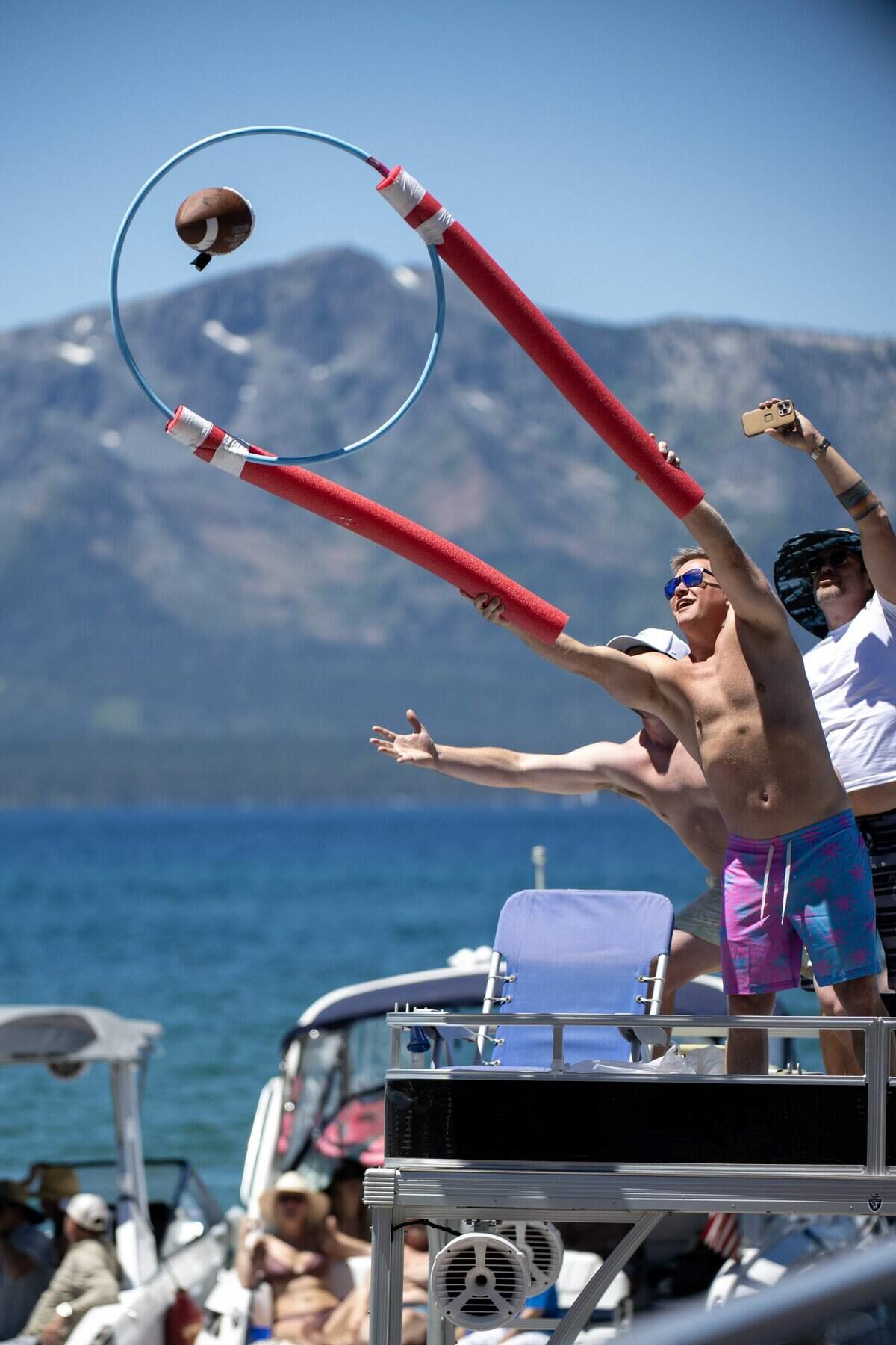 Fans engage with celebrity golfers as they get their football autographed and returned on the 17 tee during the American Century Championship at Edgewood Tahoe Golf Course in Stateline, Nev., on Friday, July 10, 2026.
