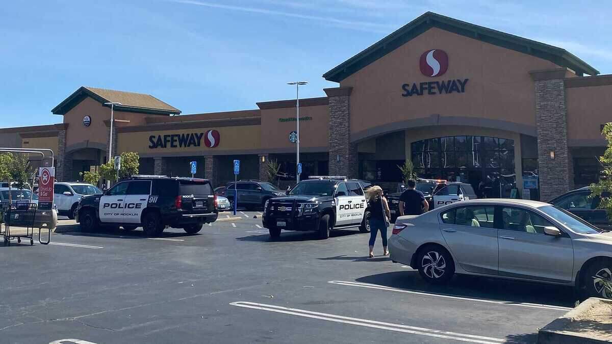 Police are seen investigating a suspected road rage incident after stopping a suspect Thursday, May 19, 2022, in the parking lot of the Safeway supermarket on Park Drive and Sunset Boulevard in Rocklin, Calif.