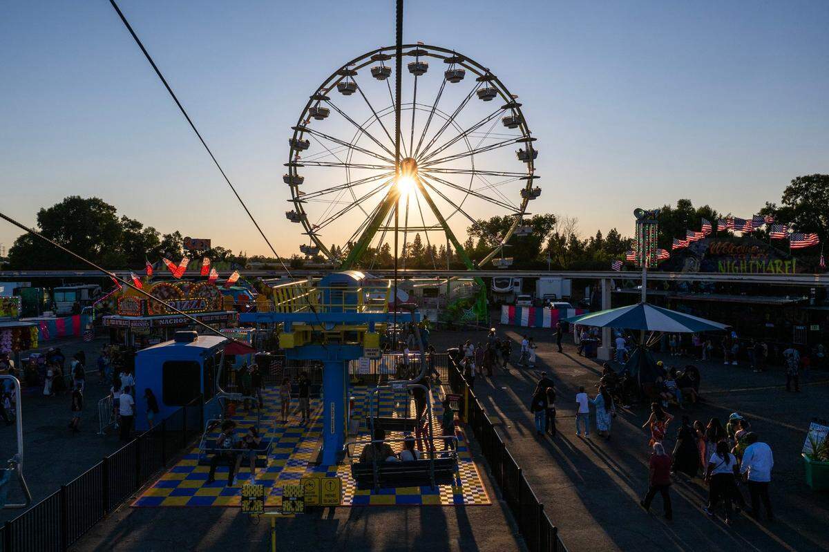 The Century Wheel towers over the midway at the California State Fair at Cal Expo earlier this month.