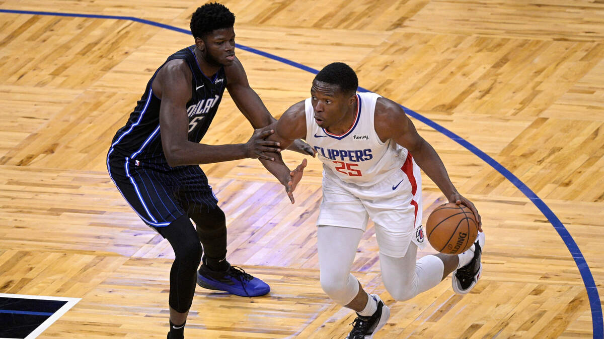 Los Angeles Clippers forward Mfiondu Kabengele (25) drives to the basket in front of Orlando Magic center Mo Bamba (5) during the second half of an NBA basketball game, Friday, Jan. 29, 2021, in Orlando, Fla. (AP Photo/Phelan M. Ebenhack)
