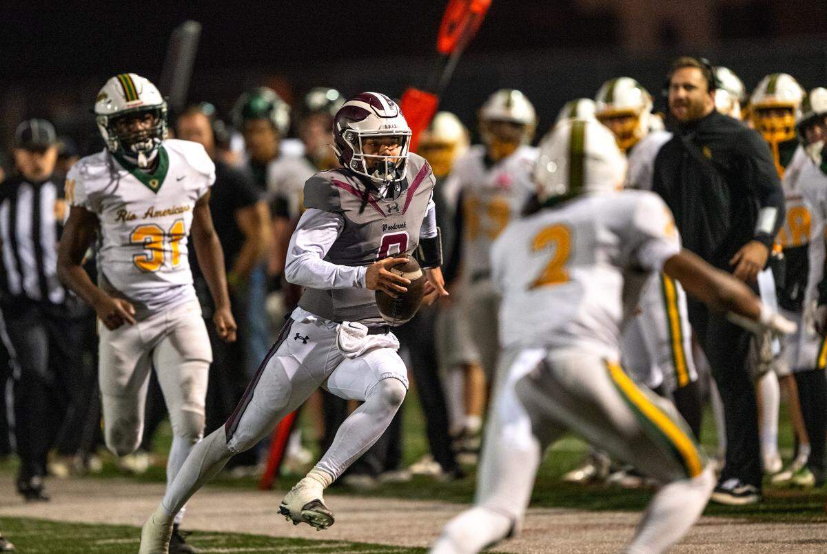 Woodcreek Timberwolves quarterback Josiah Melendez (9) runs a keeper for a first down against the Rio Americano Raiders in the second quarter of a CIF Sac-Joaquin Division III semifinal playoff game in Roseville on Friday.