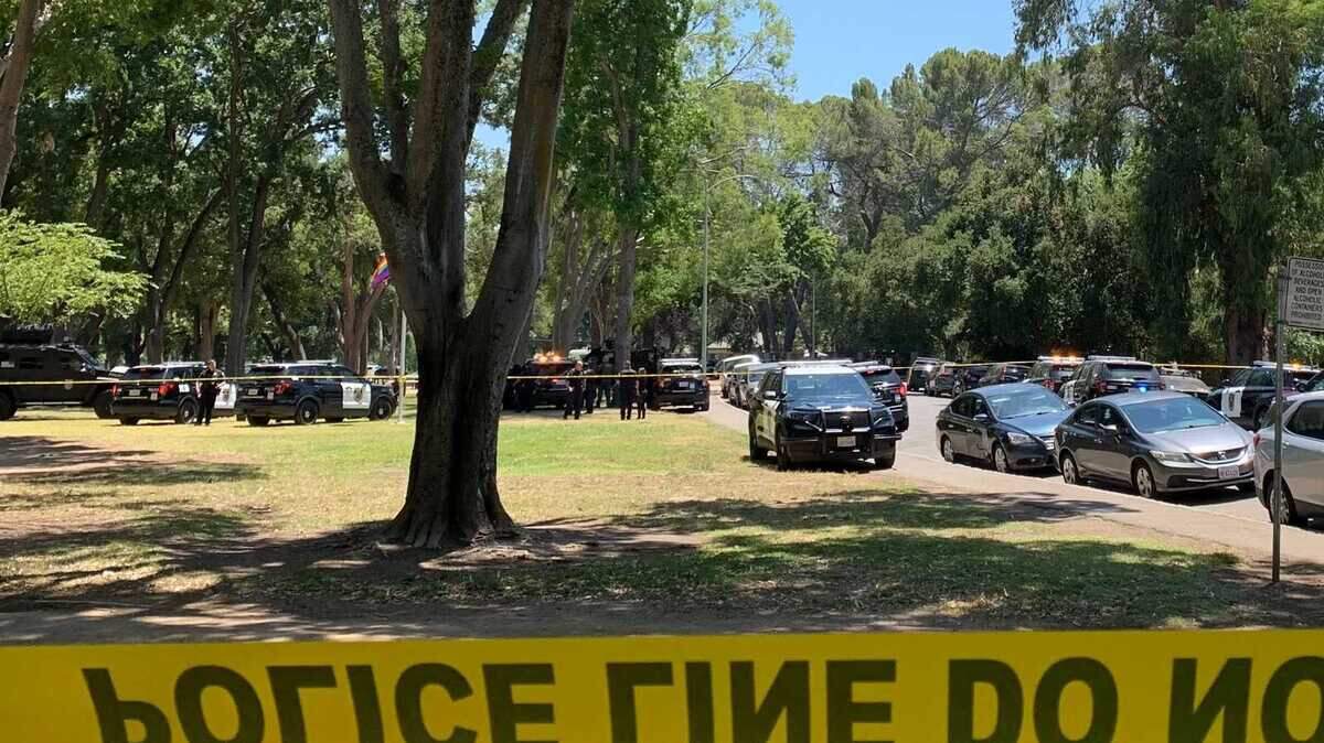 Police surround an area of William Land Park in Sacramento on Friday, June 21, 2024, after officers responded to the park for a report of a subject with a gun. Police said they have closed roadways near Land Park Drive and 17th Avenue as they negotiate with the subject.