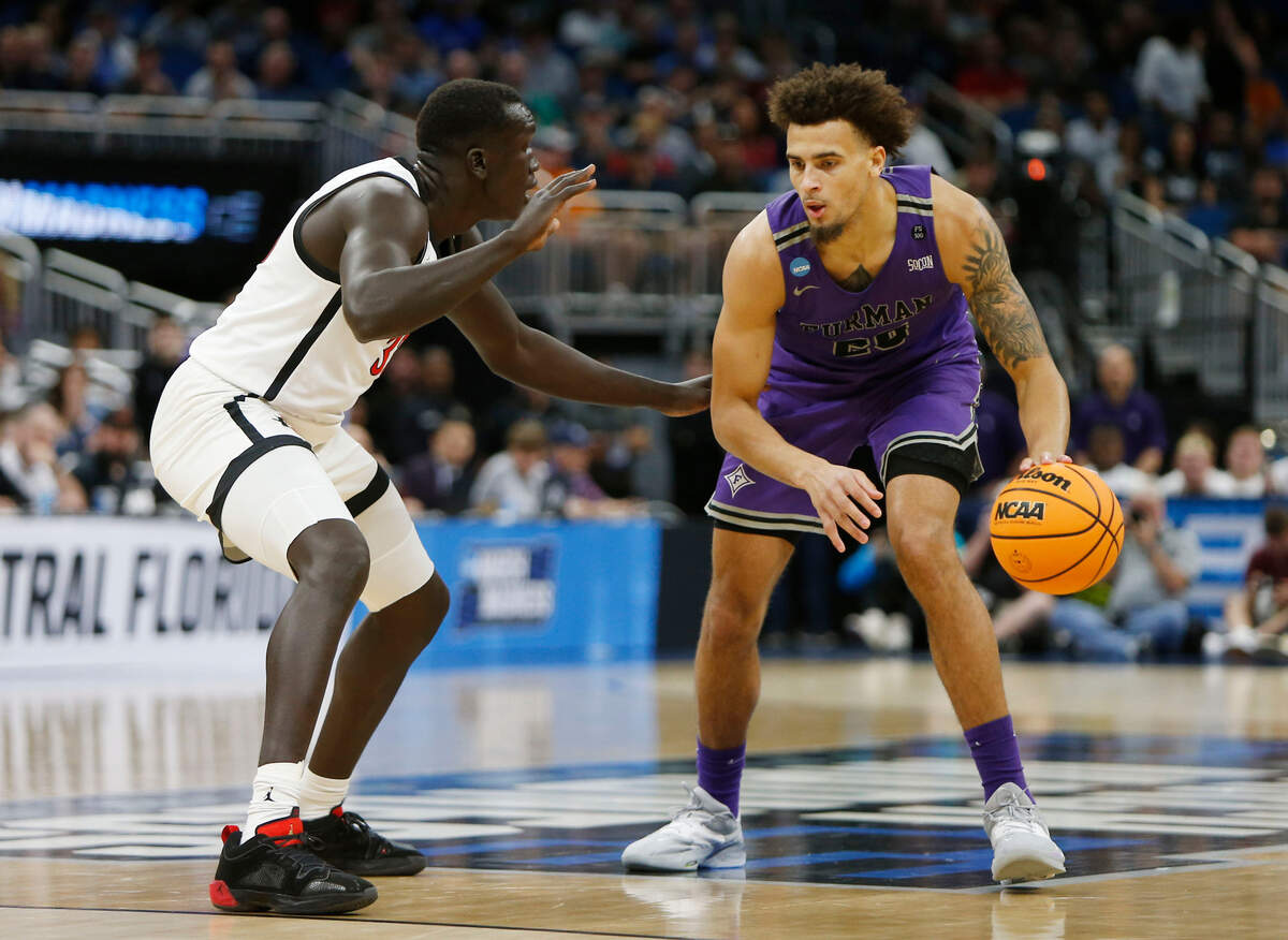 Furman Paladins forward Jalen Slawson (20) is defended by San Diego State Aztecs forward Aguek Arop (33) during the first half in the second round of the 2023 NCAA Tournament on March 18, 2023, at Legacy Arena in Orlando, Florida.