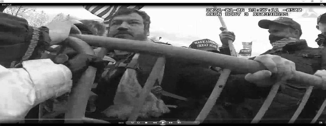 Evan Neumann, 48, of Mill Valley, seen in a bodycam video Jan. 6, 2021, is charged with assaulting officers, physical violence on Capitol grounds and other charges. He remains at large, officials said.