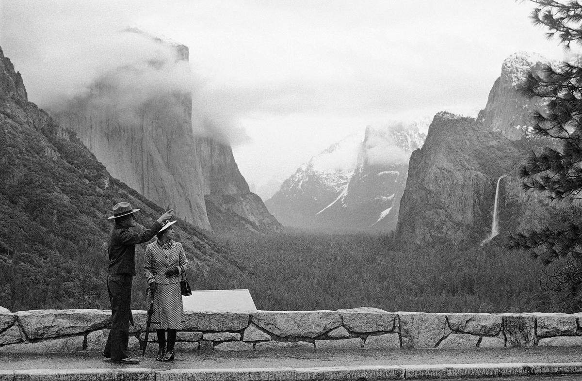 Park superintendent Bob Binnewies points out highlights from Inspiration Point to Queen Elizabeth II during her visit to Yosemite National Park on March 5, 1983.