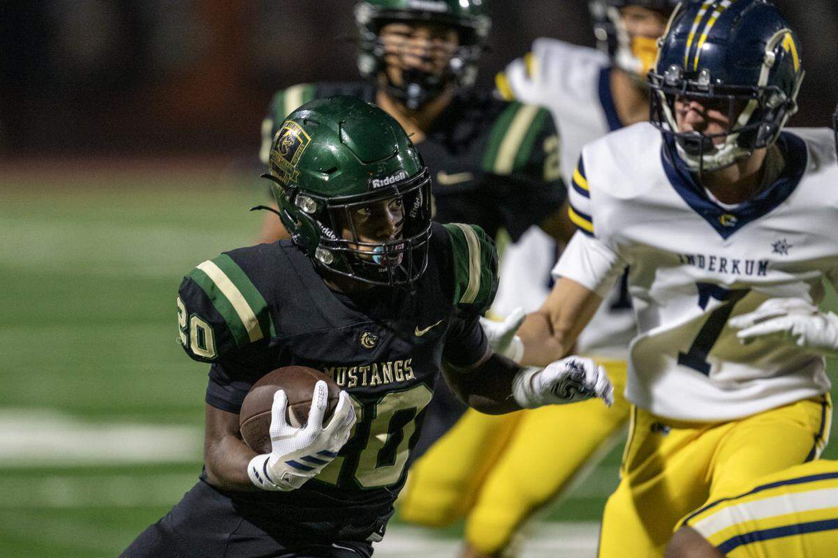 The Monterey Trail Mustangs’ Nigel Flowers (20) cuts back as he runs past the Inderkum Tigers defense in the second half of the CIF Sac-Joaquin Section Division I quarterfinal football playoff game in Elk Grove on Friday.