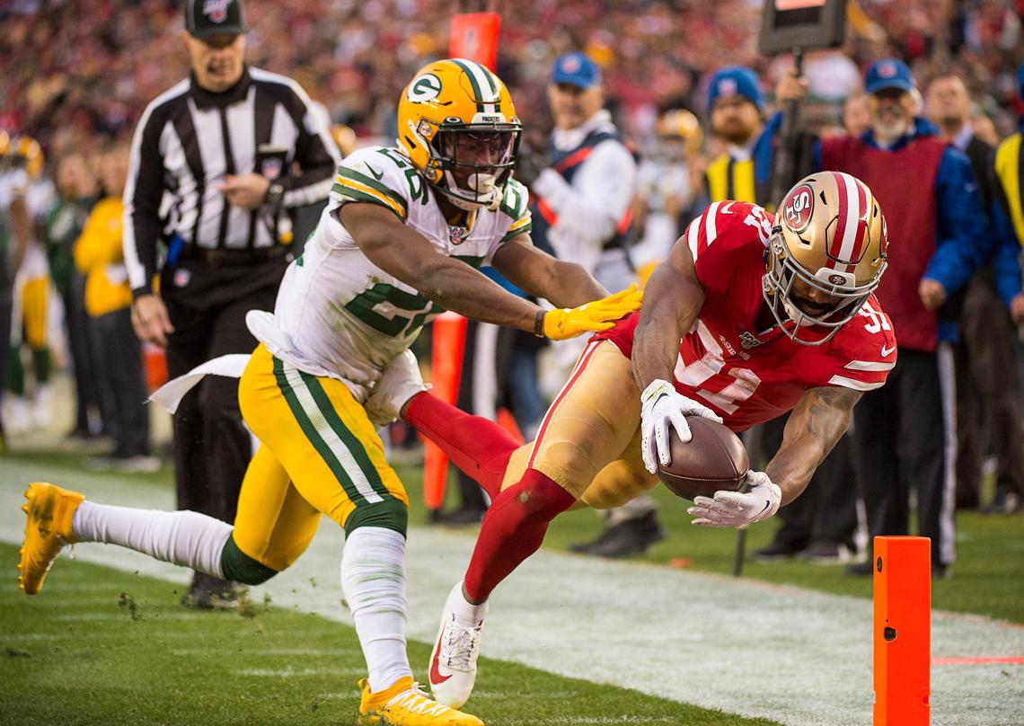 San Francisco 49ers running back Raheem Mostert (31) dives into the end zone for a touchdown defended by Green Bay Packers free safety Darnell Savage (26) in the second quarter of the NFC Championship game at the Levi’s Stadium on Sunday, Jan. 19, 2020 in Santa Clara.