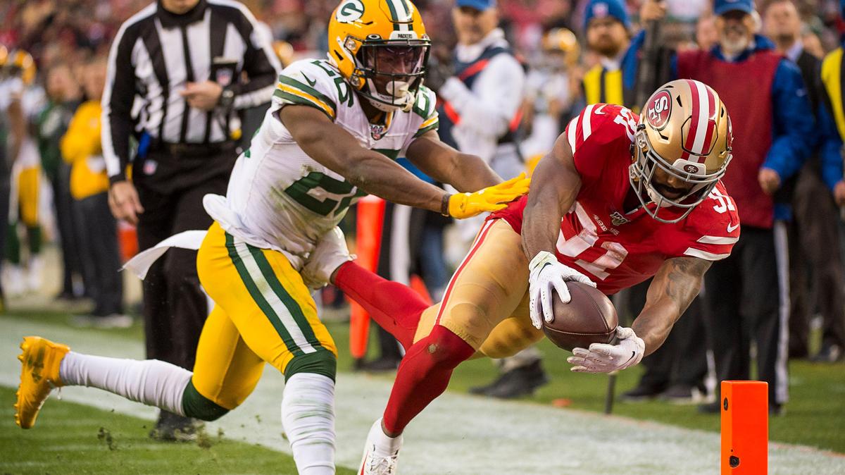 San Francisco 49ers running back Raheem Mostert (31) dives into the end zone for a touchdown defended by Green Bay Packers free safety Darnell Savage. The 49ers led 27-0 at halftime Sunday. Go to sacbee.com for more coverage of the NFC Championship.