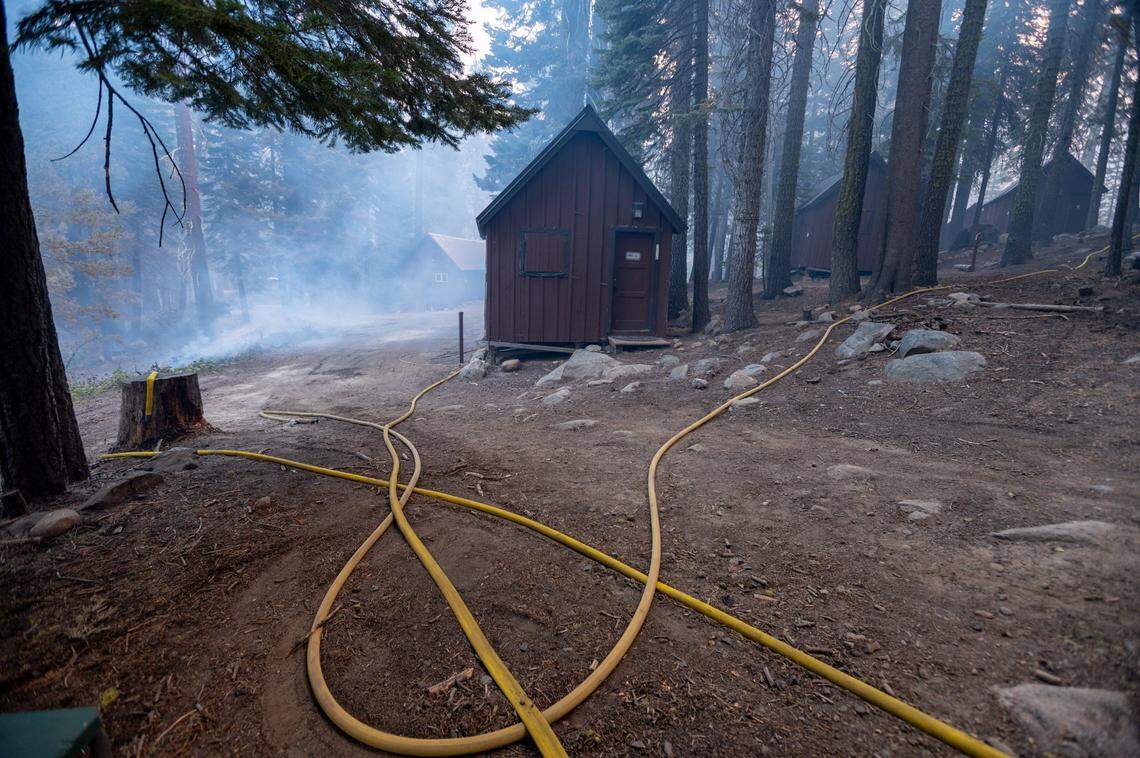 A lodge building stands at Camp Sacramento on Monday after firefighters worked through the night to save the beloved recreation site from the Caldor Fire.