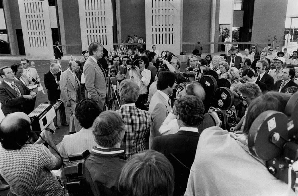 Surrounded by news cameras, presidential candidate Jimmy Carter talks to SMUD workers in a utility yard on 59th Street in East Sacramento on May 31, 1976.