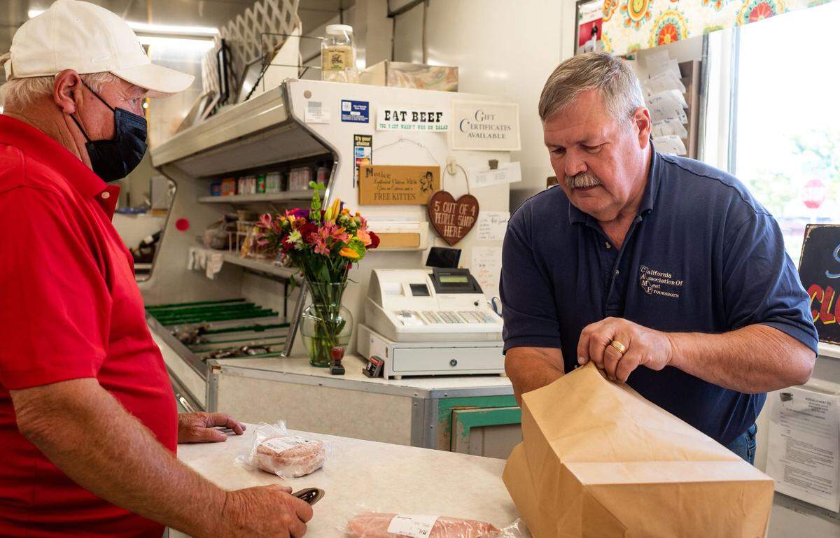 David Henry, who owns Roseville Meat Company with his wife Joyce, rings up a purchase at their longtime location on Atlantic Street on Sept. 29.