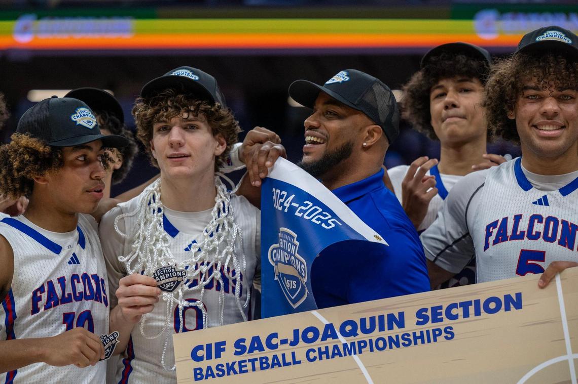 Christian Brothers interim coach Shawn Jay holds up the section banner after his team defeated the El Capitan in the Sac-Joaquin Section Championship Division III championship on Friday. He was filling in for coach Jermaine Brown, who was hospitalized on Wednesday. 