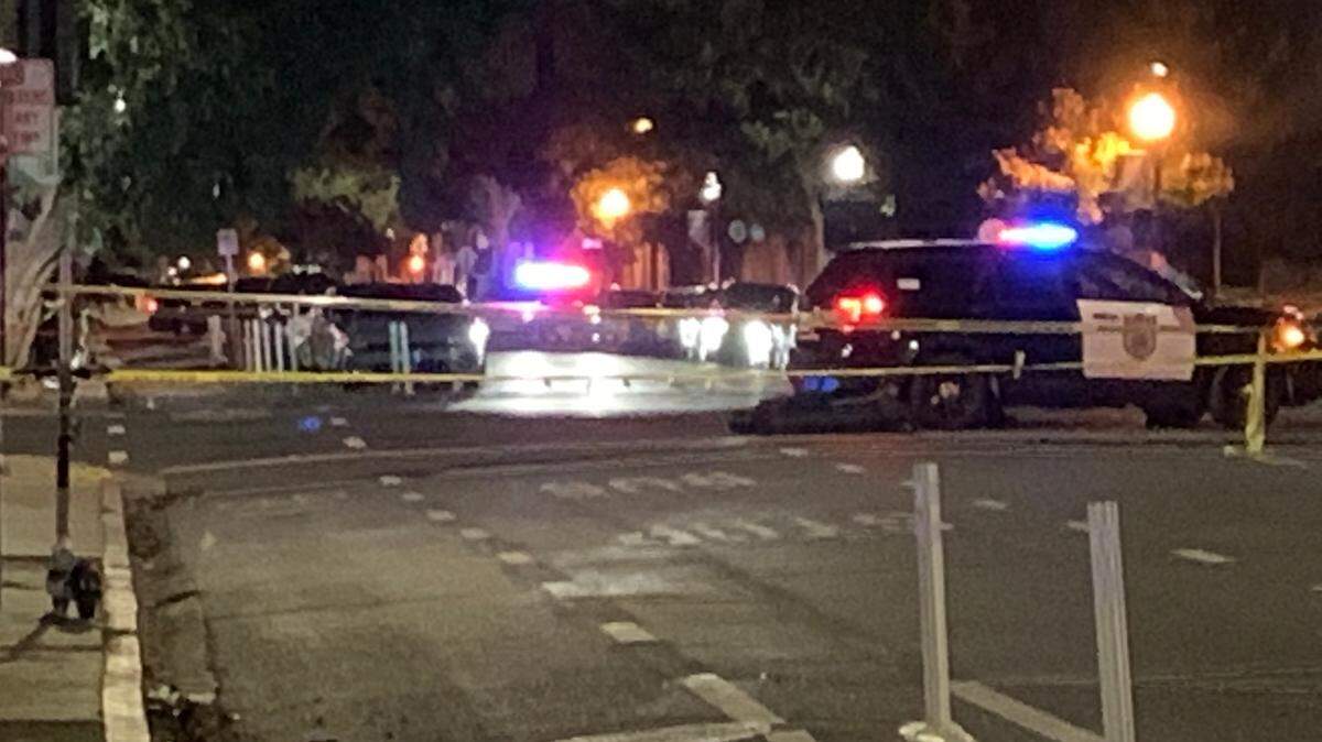 Police vehicles are seen Sunday, Sept. 25, 2022, at 29th and J streets in the midtown section of Sacramento, Calif., following a shooting. One person was killed after shots rang out along a popular nighttime corridor.