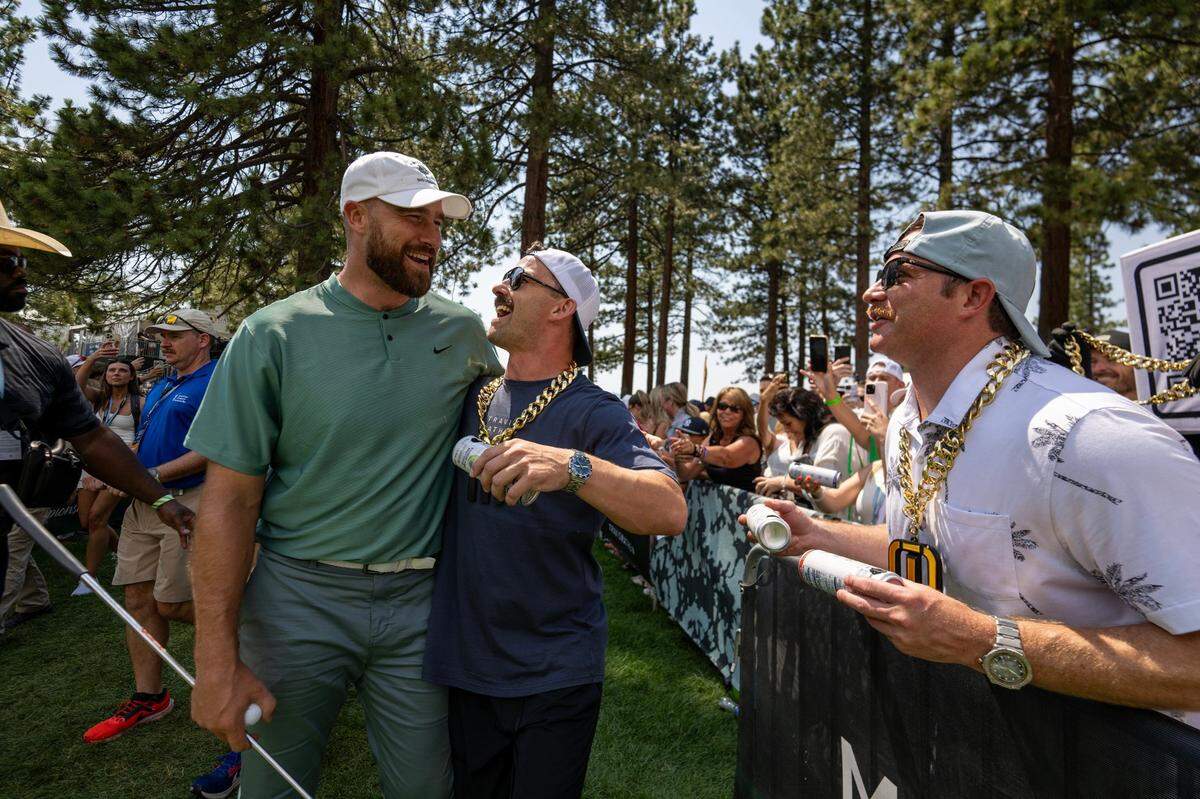 Travis Kelce embraces a fan as he makes his way to the 18th tee in the first round of the American Century celebrity golf championship on Friday, July 12, 2024, in Stateline, Nev.