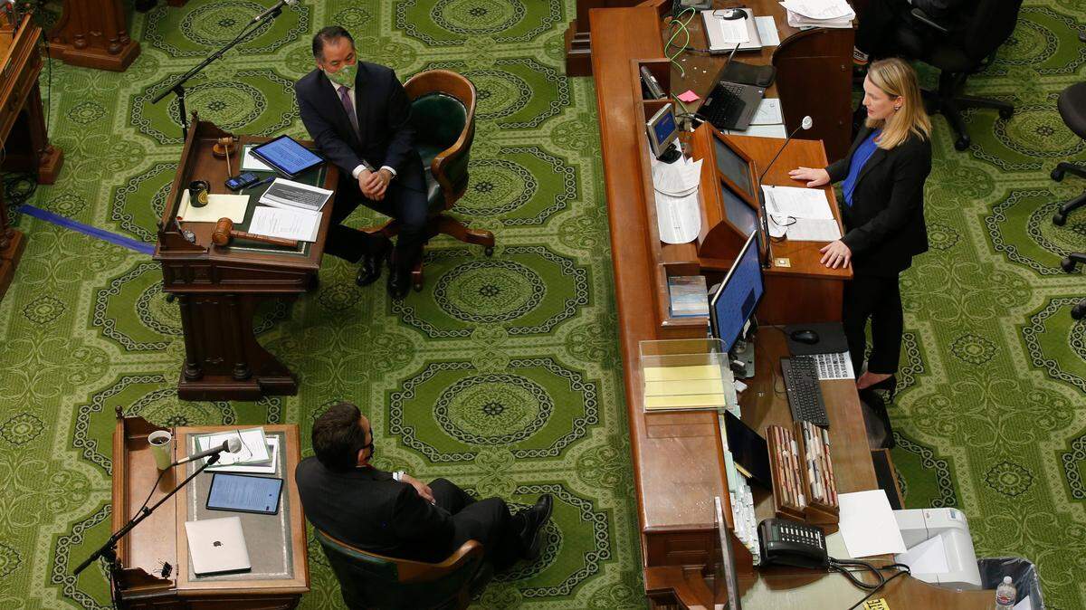 Keely Bosler, Director of Finance, right, discusses Gov. Gavin Newsom’s proposed 2020-21 revised state budget during a hearing of the Assembly “Committee of the Whole on the State Budget,” at the Capitol in Sacramento, Calif., Tuesday, May 26, 2020. Lawmakers were looking into the Newsom administration’s plan to fill an estimated $54.3 budget deficit created by the effects of the coronavirus. Seated at top left, is Assemblyman Phil Ting, D-San Francisco, chair of the Assembly budget committee, and at bottom left is Assemblyman Jay Obernolte, R-Big Bear Lake, vice chair of the budget committee, (AP Photo/Rich Pedroncelli, Pool)