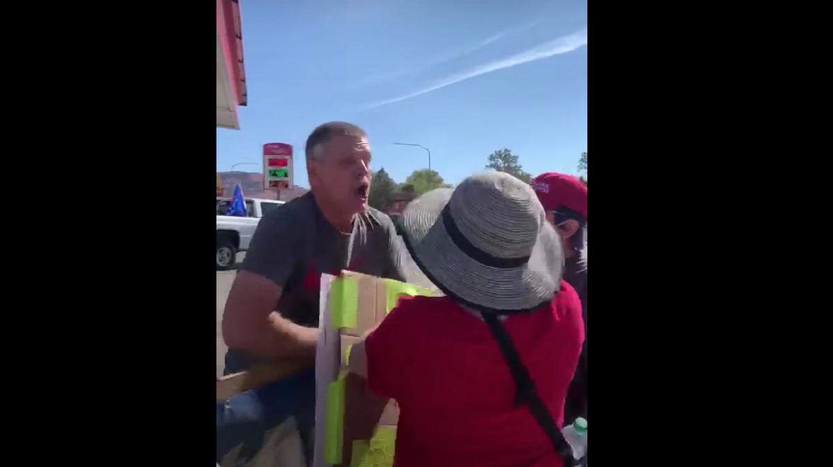 Screen shot of a Storyful video of a man coughing on anti-racism protesters in Kanab, Utah, after yelling, “I hate all you Democrats. Black lives don’t matter. All lives matter. “