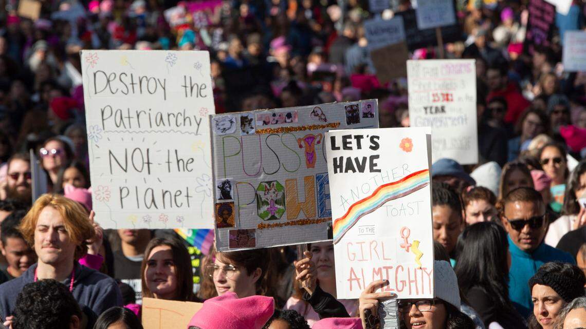 Robin Primavera and Connie Zupan wear pink beanies as they congregate at the front of a crowd of thousands to listen to speakers and watch performers on the west steps of the state Capitol during the fourth annual Women’s March Sacramento on Saturday, Jan. 18, 2020.