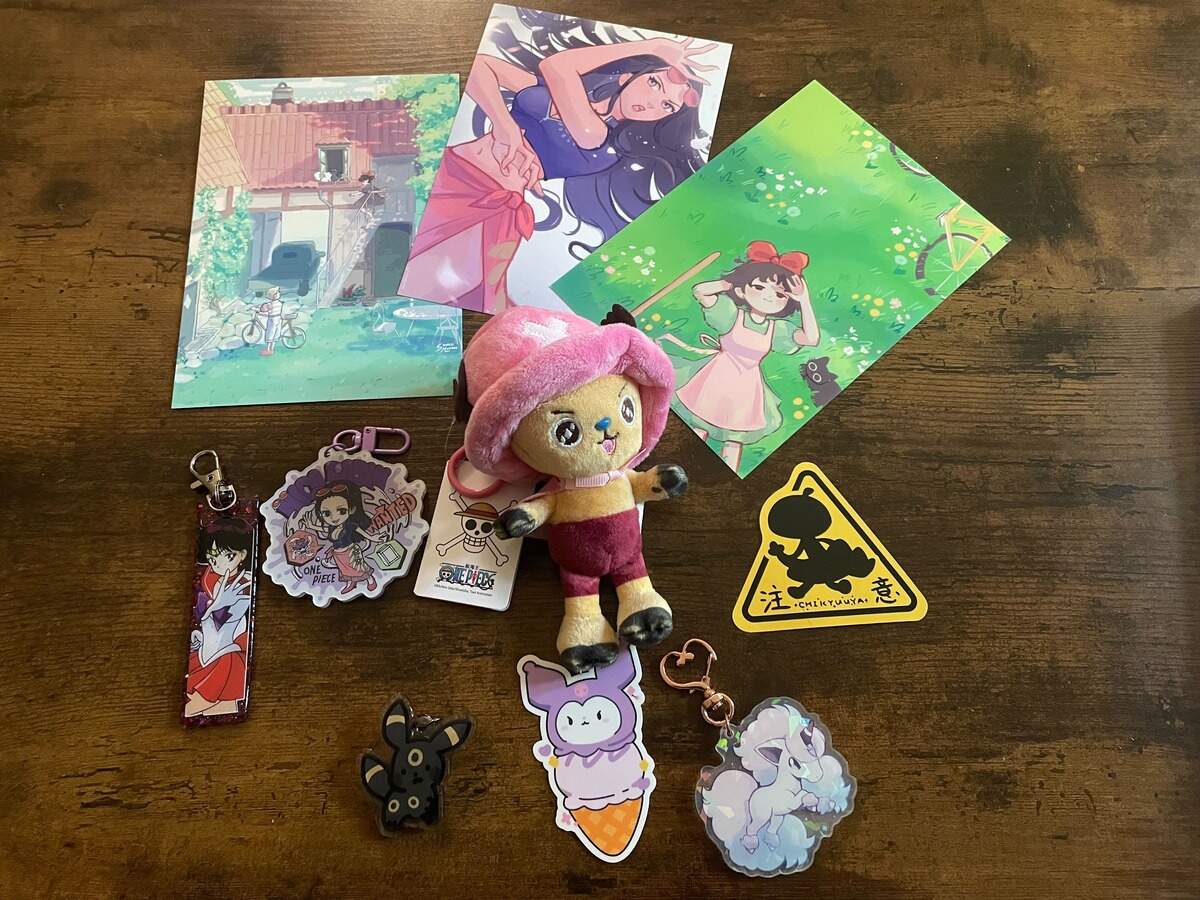 Keychains, art and stickers purchased at SacAnime Spring on April 24, 2026. The convention has a variety of merchandise available from 350 vendors.