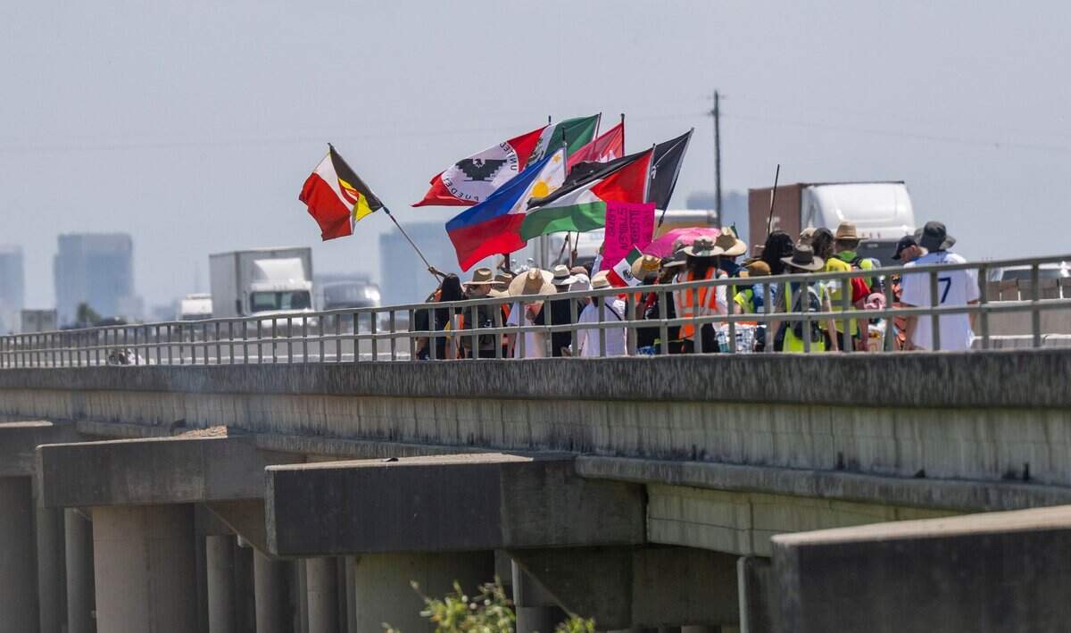 Marchers cross the Yolo Causeway bridge on Monday during a three-day walk for immigrant rights from Vacaville to the state Capitol.