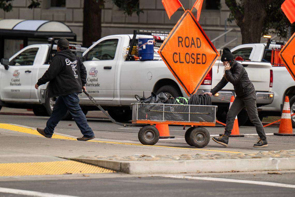 Crew members transport equipment for a scene in director Paul Thomas Anderson’s upcoming movie on H Street, closed for filming, in downtown on Saturday.