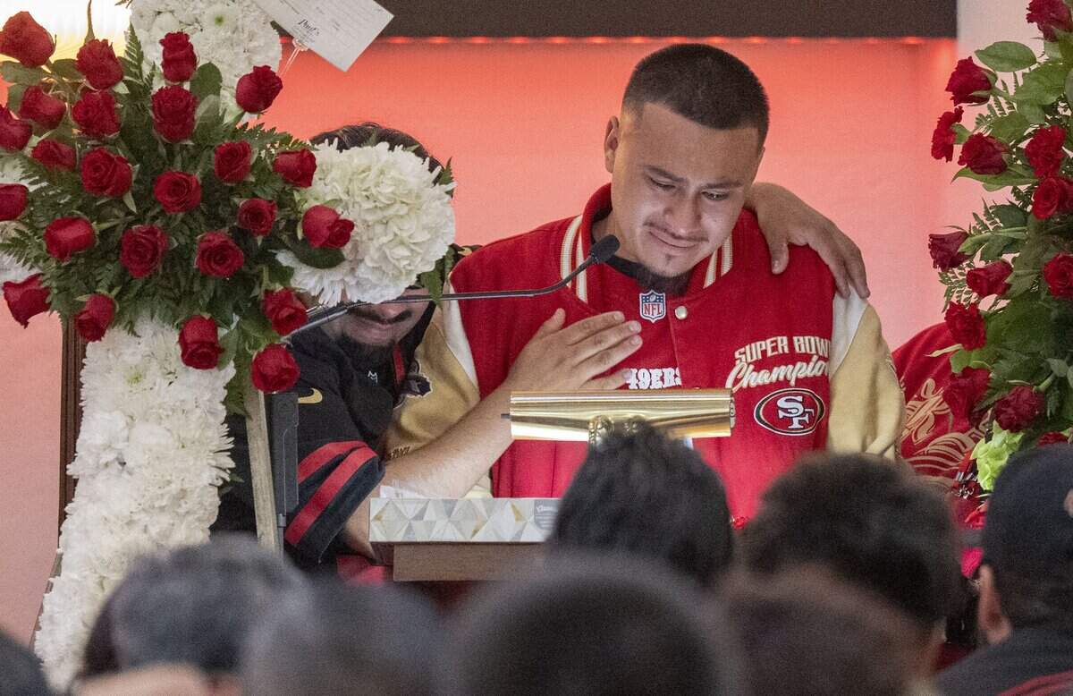 Ernesto Ramos is comforted as he speaks about his brothers Jesus and Jhony Ramos during the wake on Sunday in Daly City. "At any time or any given moment, we could all just disappear like nothing. I wish we had an open casket for them at least, just to see them one more time," Ramos said as tears rolled down his eyes.