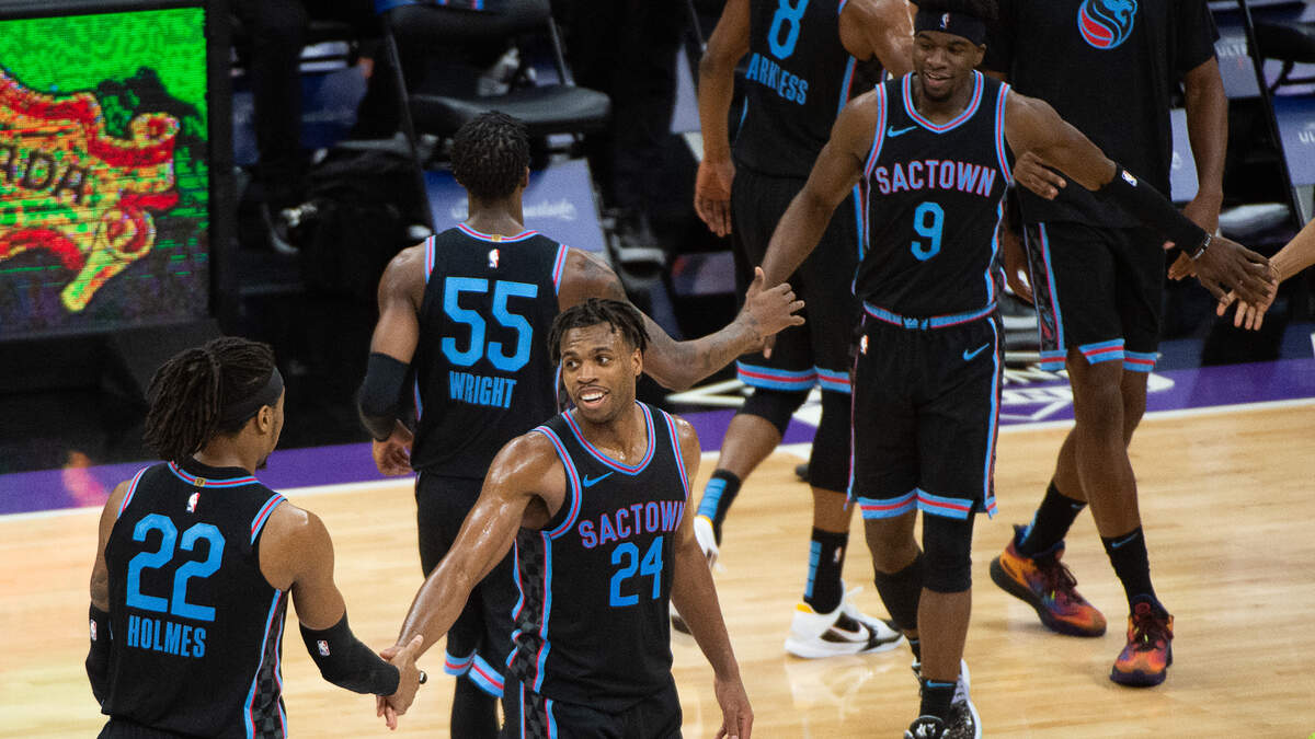 Sacramento Kings guard Buddy Hield (24) congratulates Sacramento Kings center Richaun Holmes (22) during a time out as the Kings lead in the third quarter during a game at Golden 1 Center on Tuesday, May 11, 2021 in Sacramento.