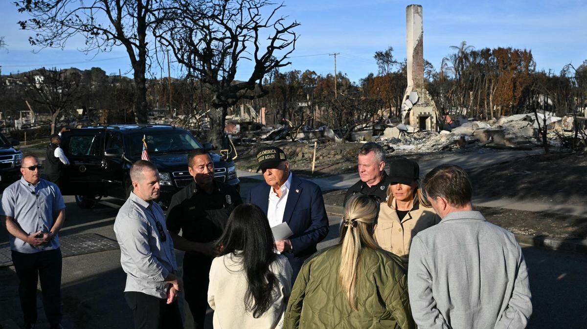 President Donald Trump and first lady Melania Trump meet residents as they tour a fire-affected area in the Pacific Palisades on Friday, Jan. 24, 2025.