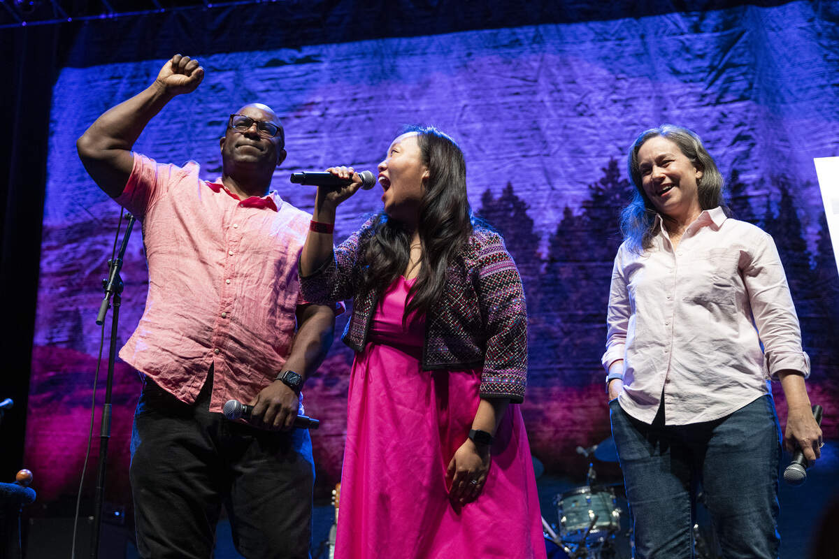 Congressional candidates Mai Vang, center, and Effie Phillips-Staley, right, joined by and former U.S. Rep. Jamaal Bowman, left, speak to the crowd before a benefit concert hosted by the two campaigns and Cake at Channel 24 in Sacramento on Sunday.