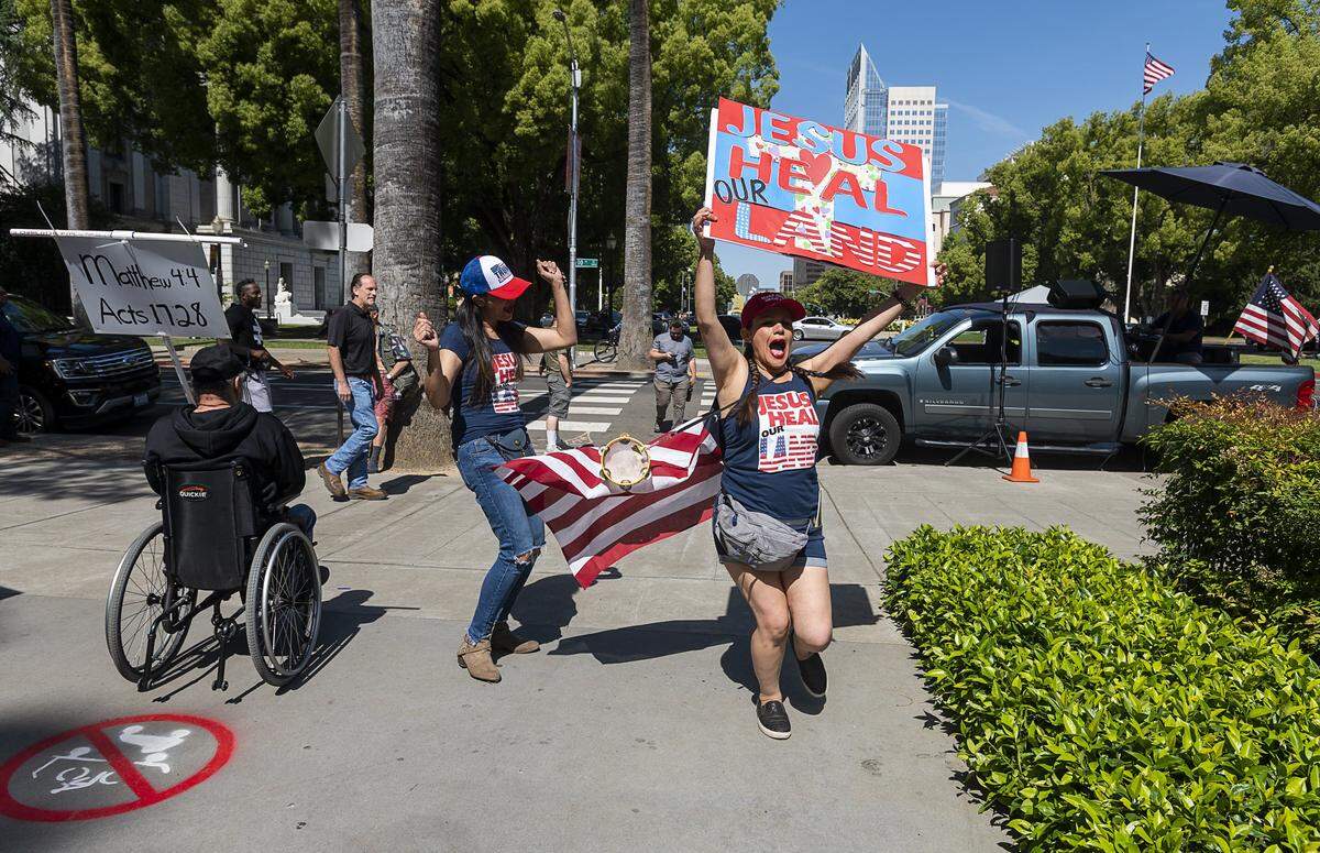 Irene Ortega of Temecula dances with Sandra during a protest at the state Capitol on Thursday, May 7, 2020 in Sacramento during the coronavirus pandemic.