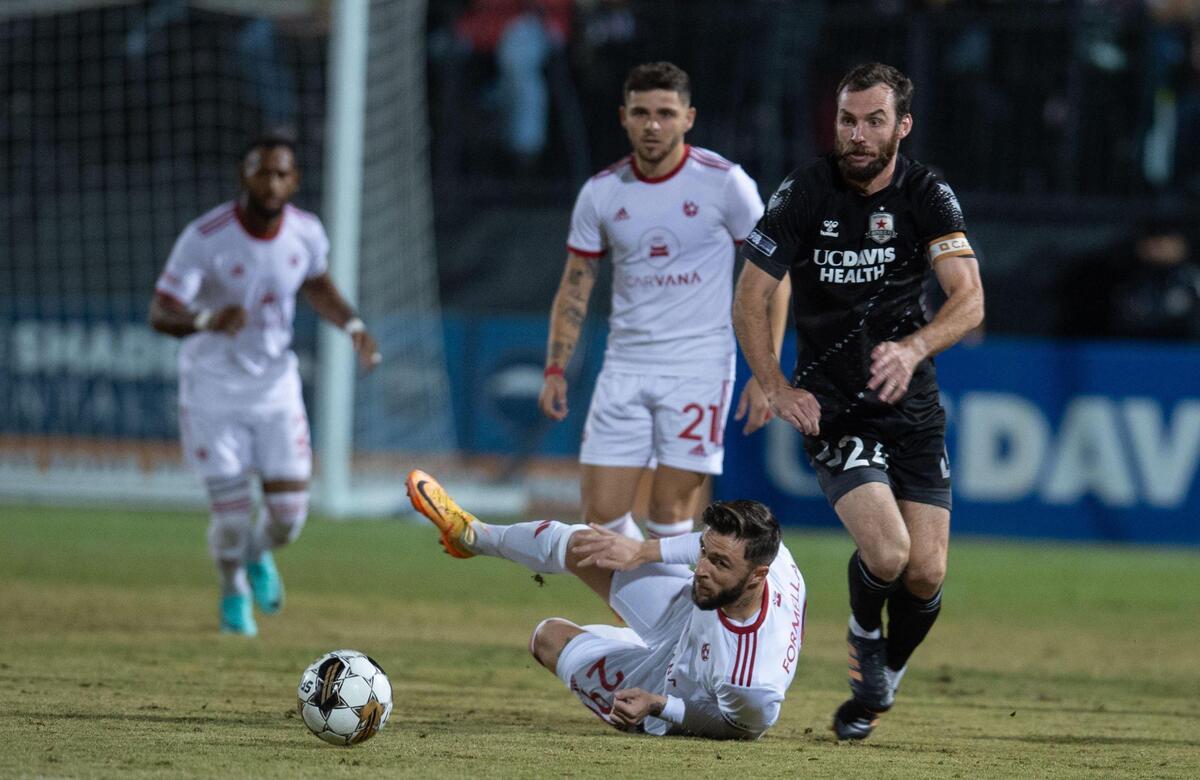 Sacramento Republic FC defender Conor Donovan (24) chases the ball against Phoenix Rising FC forward Dariusz Formella (29) during the USL Western Conference finals on Saturday, Nov. 4, 2023, at Heart Health Park in Sacramento.