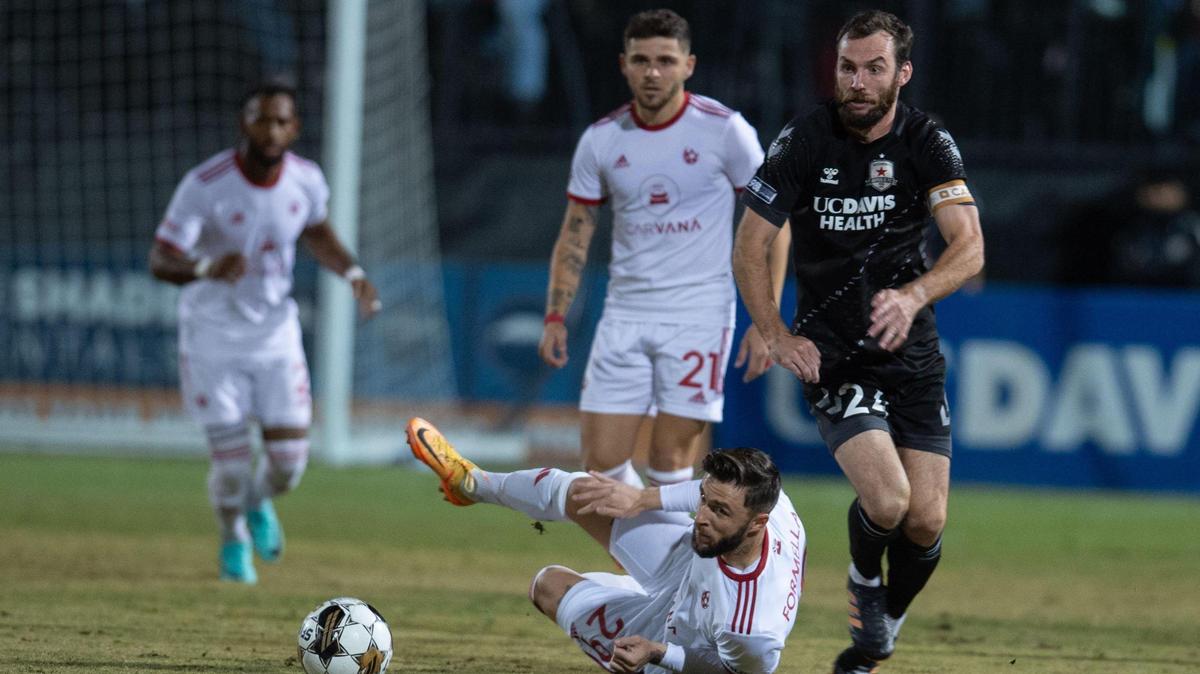 Sacramento Republic FC defender Conor Donovan (24) chases the ball against Phoenix Rising FC forward Dariusz Formella (29) during the USL Western Conference finals on Saturday, Nov. 4, 2023, at Heart Health Park in Sacramento.