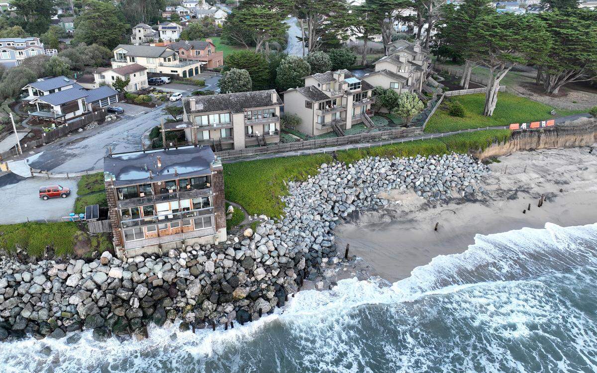 Condominiums, to the right of the building in the foreground, are seen in this drone view near Miramar Beach in Half Moon Bay on Dec. 7, 2023. The condo owners sued the Coastal Commission and won when it wouldn’t let them build a sea wall, and the case is now on appeal.