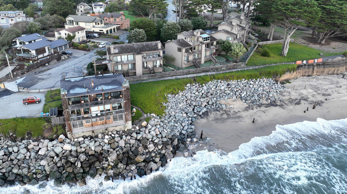 Condominiums, to the right of the building in the foreground, are seen in this drone view near Miramar Beach in Half Moon Bay on Dec. 7, 2023. The condo owners sued the Coastal Commission and won when it wouldn’t let them build a sea wall, and the case is now on appeal.