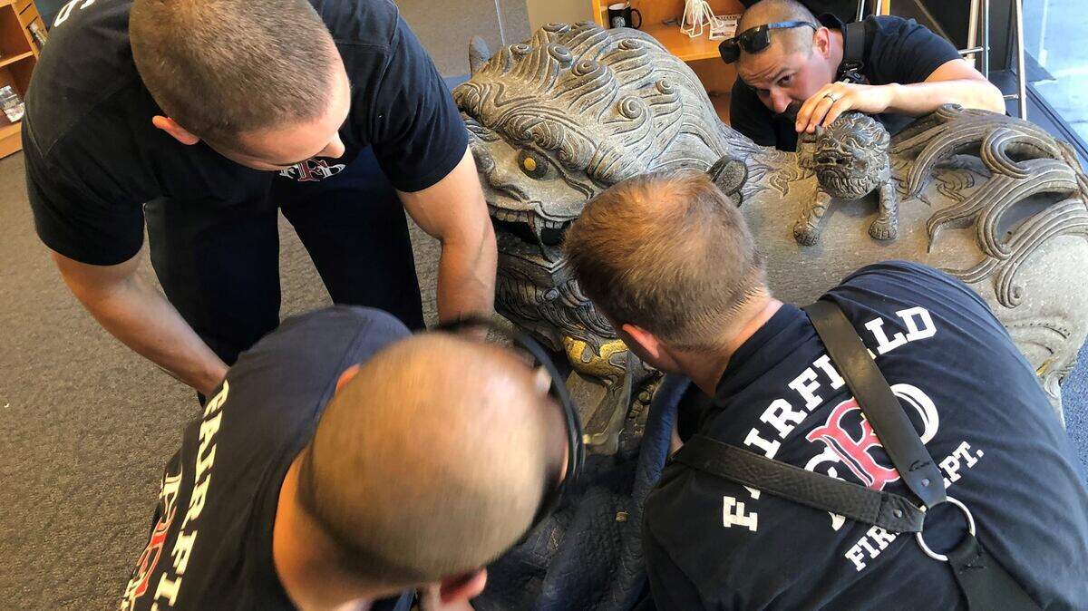 Faifield firefighters rescue a boy who got his head stuck in a statue Monday.