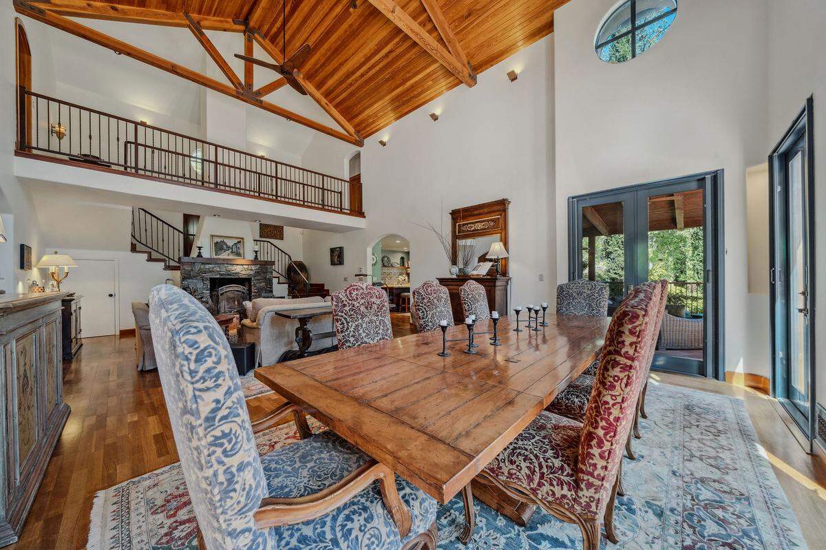 The original Tuscan-style home on the property includes high wood-beamed ceilings, a central fireplace and several French doors leading to private patios.