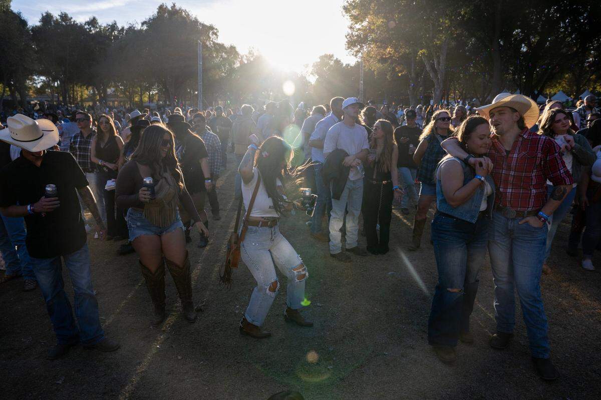 Darean Wilder and Bailey Coughman dance to Shane Smith & The Saints during the GoldenSky Country Music Festival at Discovery Park in Sacramento on Friday, Oct. 18, 2024.