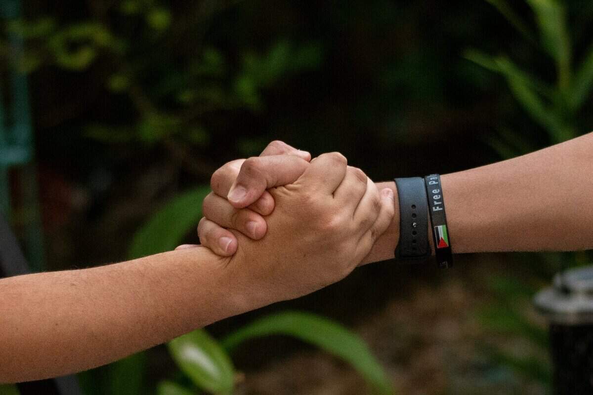 Ahmed wears a “Free Palestine” bracelet as he reaches out to a member of the family last month.