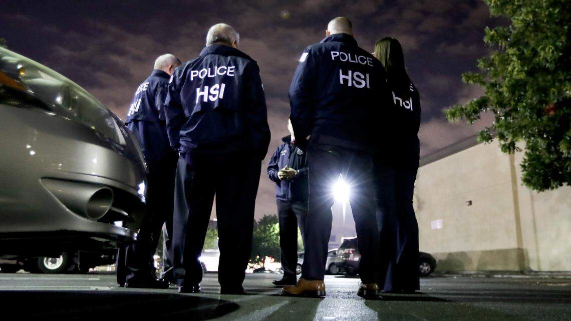 U.S. Immigration and Customs Enforcement agents gather before serving an employment audit notice at a 7-Eleven convenience store, in Los Angeles in 2018. An Oregon man who offered to pay an ICE agent up to $4,000 to deport his estranged wife and her son to El Salvador will serve four months in prison, a judge ruled on Monday.