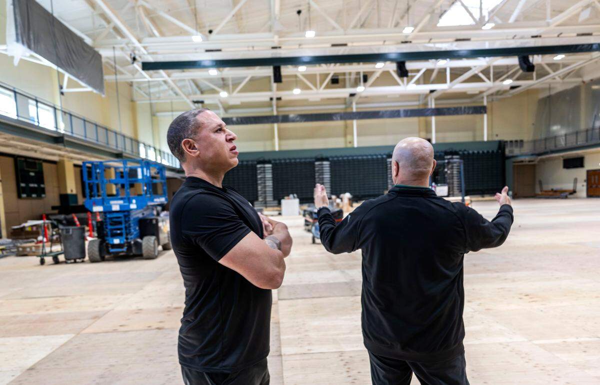 Sacramento State men’s basketball coach Mike Bibby tours the progress of The Well’s redesign in May. The Well will feature two large screens and retractable seating that will quadruple the capacity from the current venue, according to athletic director Mark Orr.