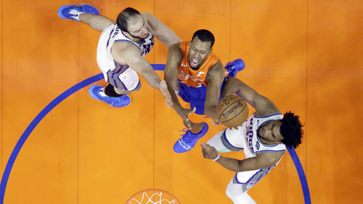Cleveland Cavaliers’ Rodney Hood, center, drives to the basket between Sacramento Kings’ Kosta Koufos, left, and Sacramento Kings’ Marvin Bagley III in the first half of an NBA basketball game, Friday, Dec. 7, 2018, in Cleveland.