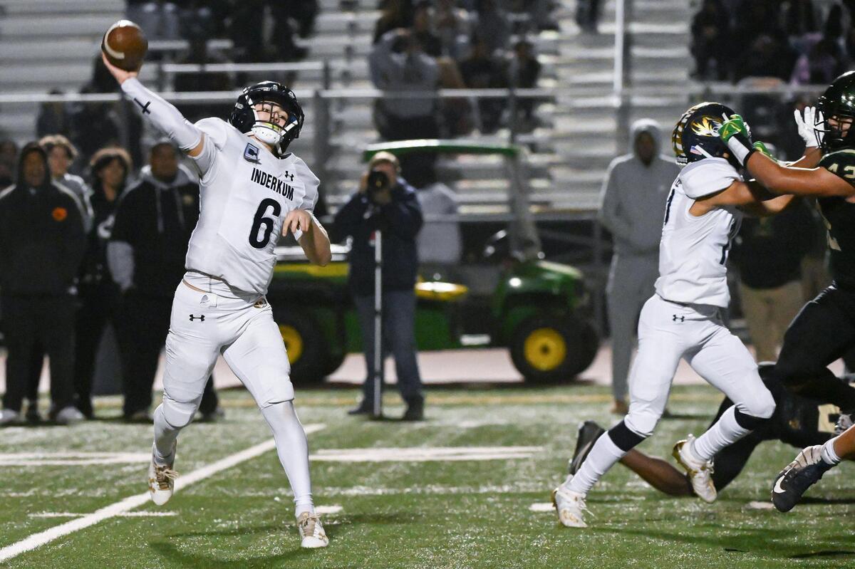 Inderkum Tigers quarterback Ricky Cole (6) passes for a first down in the second half of a CIF Sac-Joaquin Division I football quarterfinal on Friday in Elk Grove.