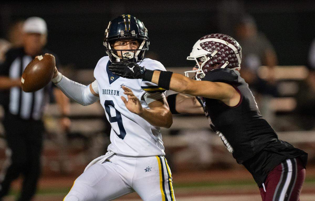 The Inderkum Tigers’ Brody Cole (9) throws away the ball under pressure by the Woodcreek Timberwolves' Kegan Nitterhouse (6) on Friday in Roseville. 