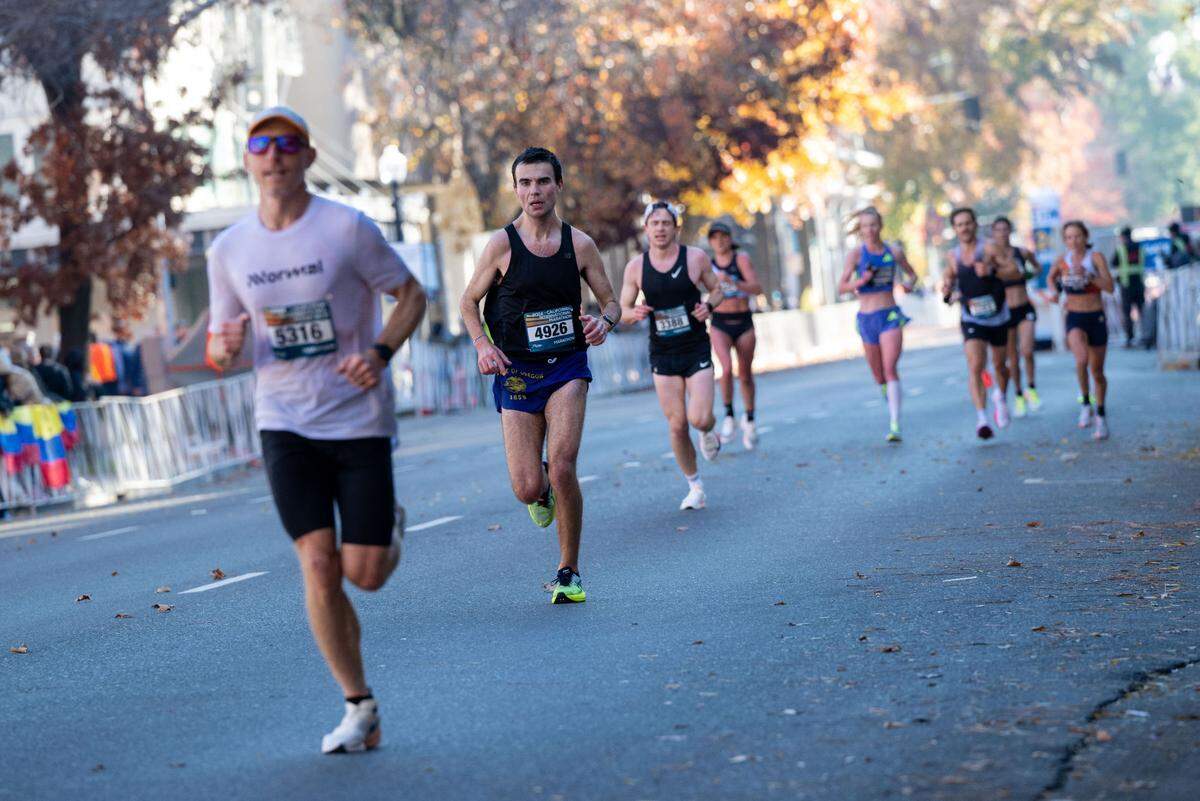 Competitors run down L Street to the finish line during the California International Marathon in 2024.